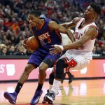 Phoenix Suns guard Brandon Knight (3) runs into Chicago Bulls guard Jimmy Butler (21) during the second half of an NBA basketball game in Chicago, on Saturday, Feb. 21, 2015. The Bulls won the game 112-107. (AP Photo/Jeff Haynes)