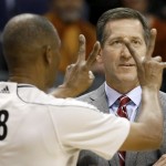 Phoenix Suns head coach Jeff Hornacek looks at his team as referee Michael Smith (38) calls a foul during the first half of an NBA basketball game against the Indiana Pacers, Tuesday, Dec. 2, 2014, in Phoenix. (AP Photo/Matt York)