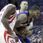 Phoenix Suns' Markieff Morris, center, tries to hold onto the ball between Houston Rockets James Harden, left, and Francisco Garcia in the first half of an NBA basketball game Saturday, Dec. 6, 2014, in Houston. (AP Photo/Pat Sullivan)
