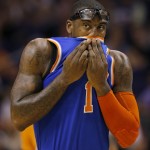  New York Knicks' Amare Stoudemire wipes his face during the first half of an NBA basketball game against the Phoenix Suns, Friday, March 28, 2014, in Phoenix. (AP Photo/Matt York)
