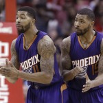 Phoenix Suns Markieff Morris (11) and Marcus Morris (15) talk to a referee in the second half of an NBA basketball game against the Houston Rockets Saturday, Dec. 6, 2014, in Houston. The Rockets won 100-95. (AP Photo/Pat Sullivan)