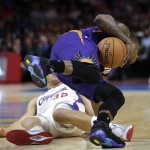Phoenix Suns' Eric Bledsoe, front, collides with Los Angeles Clippers' Blake Griffin during the first half of an NBA basketball game Monday, Dec. 8, 2014, in Los Angeles. (AP Photo/Jae C. Hong)