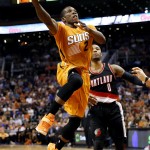 Phoenix Suns' Eric Bledsoe (2) drives against Portland Trail Blazers' Damien Lillard (0) during the second half of an NBA basketball game, Friday, March 27, 2015, in Phoenix. The Trail Blazers won 87-81. (AP Photo/Matt York)