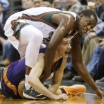 Milwaukee Bucks' Khris Middleton gets tangled with Phoenix Suns' Goran Dragic going after a loose ball during the first half of an NBA basketball game Tuesday, Jan. 6, 2015, in Milwaukee. (AP Photo/Morry Gash)