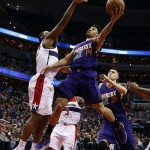 Phoenix Suns guard Gerald Green (14) shoots over Washington Wizards center Kevin Seraphin (13), from France, in the first half of an NBA basketball game, Sunday, Dec. 21, 2014, in Washington. (AP Photo/Alex Brandon)