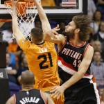 Phoenix Suns' Alex Len (21) dunks against Portland Trail Blazers' Robin Lopez (42) during the first half of an NBA basketball game, Friday, March 27, 2015, in Phoenix. (AP Photo/Matt York)