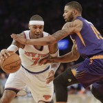 New York Knicks' Carmelo Anthony (7) drives past Phoenix Suns' Marcus Morris (15) during the second half of an NBA basketball game, Saturday, Dec. 20, 2014, in New York. The Suns won the game 99-90. (AP Photo/Frank Franklin II)
