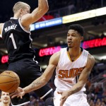Phoenix Suns' Gerald Green, right, passes the ball off to a teammate as Brooklyn Nets' Mason Plumlee (1) defends during the second half of an NBA basketball game Wednesday, Nov. 12, 2014, in Phoenix. The Suns defeated the Nets 112-104. (AP Photo/Ross D. Franklin)