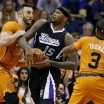 Sacramento Kings center DeMarcus Cousins (15) works between Phoenix Suns center Miles Plumlee and Suns' Isaiah Thomas (3) during the first half of an NBA basketball game, Friday, Nov. 7, 2014, in Phoenix. The Kings won 114-112 in double overtime. (AP Photo/Matt York)