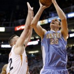 Denver Nuggets' Timofey Mozgov (25), of Russia, shoots and scores over Phoenix Suns' Miles Plumlee, left, during the first half of an NBA basketball game Wednesday, Nov. 26, 2014, in Phoenix. (AP Photo/Ross D. Franklin)