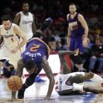Phoenix Suns' Eric Bledsoe, left, falls to the court after he was fouled by Los Angeles Clippers' Jamal Crawford during the second half of an NBA basketball game Monday, Dec. 8, 2014, in Los Angeles. The Clippers won 121-120 in overtime. (AP Photo/Jae C. Hong)