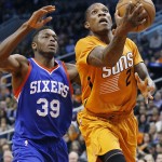 Phoenix Suns' Eric Bledsoe (2) drives past Philadelphia 76ers' Jerami Grant (39) to score during the second half of an NBA basketball game Friday, Jan. 2, 2015, in Phoenix. The Suns defeated the 76ers 112-96. (AP Photo/Ross D. Franklin)
