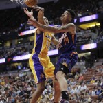 Phoenix Suns' Gerald Green, right, is fouled by Los Angeles Lakers' Wesley Johnson during overtime of a preseason NBA basketball game on Tuesday, Oct. 21, 2014, in Anaheim, Calif. The Suns won 114-108. (AP Photo/Jae C. Hong)