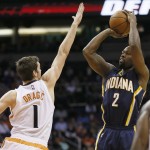 Indiana Pacers guard Rodney Stuckey (2) shoots over Phoenix Suns guard Goran Dragic (1) defends defends during the first half of an NBA basketball game, Tuesday, Dec. 2, 2014, in Phoenix. (AP Photo/Matt York)