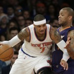 Phoenix Suns' P.J. Tucker defends New York Knicks' Carmelo Anthony, left, during the first half of an NBA basketball game Saturday, Dec. 20, 2014, in New York. (AP Photo/Frank Franklin II)