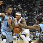 Phoenix Suns guard Isaiah Thomas (3) loses the ball as he drives between Memphis Grizzlies guard Mike Conley (11) and foward Tony Allen (9) in the second half of an NBA basketball game Sunday, Jan. 11, 2015, in Memphis, Tenn. (AP Photo/Brandon Dill)
