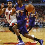 Phoenix Suns guard Brandon Knight (3) is guarded by Chicago Bulls guard Derrick Rose (1) during the second half of an NBA basketball game in Chicago, on Saturday, Feb. 21, 2015. The Bulls won the game 112-107. (AP Photo/Jeff Haynes)
