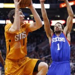 Phoenix Suns' Goran Dragic, left, of Slovenia, drives to the basket as Philadelphia 76ers' Michael Carter-Williams, right, defends during the second half of an NBA basketball game Friday, Jan. 2, 2015, in Phoenix. The Suns defeated the 76ers 112-96. (AP Photo/Ross D. Franklin)
