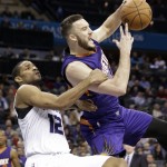 Charlotte Hornets' Gary Neal, left, fouls Phoenix Suns' Miles Plumlee during the second half of an NBA basketball game in Charlotte, N.C., Wednesday, Dec. 17, 2014. The Suns won 111-106. (AP Photo/Chuck Burton)
