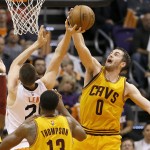 Cleveland Cavaliers' Kevin Love (0) block the shot of Phoenix Suns' Alex Len during the first half of an NBA basketball game, Tuesday, Jan. 13, 2015, in Phoenix. (AP Photo/Matt York)