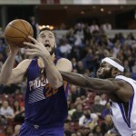 Phoenix Suns center Mile Plumlee, left, is fouled by Sacramento Kings forward Reggie Evans during the first quarter of an NBA basketball game in Sacramento, Calif., Friday, Dec. 26, 2014. (AP Photo/Rich Pedroncelli)
