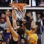 Chicago Bulls' Joakim Noah, left, and Phoenix Suns' Markieff Morris look for a rebound during the second half of an NBA basketball game Friday, Jan. 30, 2015, in Phoenix. The Suns defeated the Bulls 99-93. (AP Photo/Ross D. Franklin)