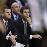 Boston Celtics head coach Brad Stevens, right, watches play with assistant coach Jay Larranaga, left, and Jamie Young, rear, during the first quarter of an NBA basketball game against the Phoenix Suns in Boston, Monday, Nov. 17, 2014. (AP Photo/Charles Krupa)
