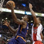 Phoenix Suns' Eric Bledsoe, left, scores in front of Toronto Raptors' DeMar DeRozan during the second half of an NBA basketball game in Toronto on Monday, Nov. 24, 2014. (AP Photo/The Canadian Press, Darren Calabrese)