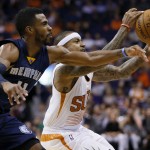 Phoenix Suns guard Isaiah Thomas reaches for the ball as Memphis Grizzlies guard Mike Conley, left, defends during the second half of an NBA basketball game, Wednesday, Nov. 5, 2014, in Phoenix. The Grizzlies won 102-91. (AP Photo/Matt York)