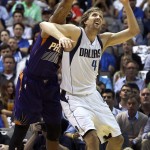 Dallas Mavericks forward Dirk Nowitzki, right, of Germany has the ball knocked away by Phoenix Suns forward Marcus Morris in the first half of the NBA basketball game in Dallas on Wednesday, April 8, 2015. (AP Photo/Brad Loper)