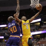 Los Angeles Lakers' Wayne Ellington, right, puts up a shot against Phoenix Suns' Anthony Tolliver during the first half of a preseason NBA basketball game on Tuesday, Oct. 21, 2014, in Anaheim, Calif. (AP Photo/Jae C. Hong)