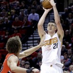 Phoenix Suns center Alex Len, from Ukraine, right, shoots over Portland Trail Blazers center Robin Lopez during the first half of an NBA basketball game in Portland, Ore., Thursday, Feb. 5, 2015. (AP Photo/Don Ryan)