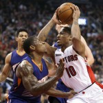 Toronto Raptors' DeMar DeRozan, right, drives into Phoenix Suns' Eric Bledsoe while going to the basket in the first half of an NBA basketball game in Toronto on Monday, Nov. 24, 2014. (AP Photo/The Canadian Press, Darren Calabrese)