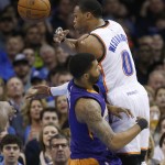 Oklahoma City Thunder guard Russell Westbrook (0) is called for an offensive foul on Phoenix Suns forward Markieff Morris, left, in the second quarter of an NBA basketball game in Oklahoma City, Sunday, Dec. 14, 2014. Oklahoma City won 112-88. (AP Photo/Sue Ogrocki)