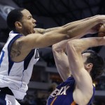 Phoenix Suns guard Goran Dragic, right, of Slovenia, is fouled by Dallas Mavericks guard Devin Harris during the first half of an NBA basketball game on Saturday, April 12, 2014, in Dallas. (AP Photo/LM Otero)