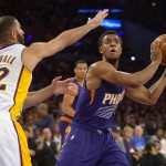  Los Angeles Lakers guard Kendall Marshall (12) guards Phoenix Suns guard Ish Smith (3) as he looks for the open in the first half of an NBA basketball game, Sunday, March 30, 2014, in Los Angeles.(AP Photo/Gus Ruelas)