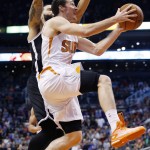 Phoenix Suns' Goran Dragic, right, of Slovenia, drives past Brooklyn Nets' Deron Williams for a score during the second half of an NBA basketball game Wednesday, Nov. 12, 2014, in Phoenix. The Suns defeated the Nets 112-104. (AP Photo/Ross D. Franklin)