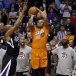 Phoenix Suns forward P.J. Tucker (17) goes up for a 3-pointer, but misses, at the end of the second overtime of an NBA basketball game, as Sacramento Kings forward Carl Landry defends, Friday, Nov. 7, 2014, in Phoenix. The Kings won 114-112. (AP Photo/Matt York)