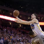 Golden State Warriors' Klay Thompson, right, lays up a shot over Phoenix Suns' Markieff Morris during the second half of an NBA basketball game Thursday, April 2, 2015, in Oakland, Calif. (AP Photo/Ben Margot)