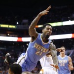 Denver Nuggets' Wilson Chandler (21) charges into Phoenix Suns' Markieff Morris, left, during the first half of an NBA basketball game Wednesday, Nov. 26, 2014, in Phoenix. (AP Photo/Ross D. Franklin)