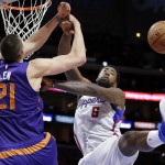 Los Angeles Clippers' DeAndre Jordan, right, blocks a shot by Phoenix Suns' Alex Len, of Ukraine, during the second half of an NBA basketball game Monday, Dec. 8, 2014, in Los Angeles. The Clippers won 121-120 in overtime. (AP Photo/Jae C. Hong)