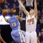 Phoenix Suns' Alex Len (21), of Ukraine, defends as Denver Nuggets' Arron Afflalo (10) tries to get off a shot during the second half of an NBA basketball game Wednesday, Nov. 26, 2014, in Phoenix. The Suns defeated the Nuggets 120-112. (AP Photo/Ross D. Franklin)