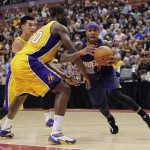 Phoenix Suns' Isaiah Thomas, right, is pressured by Los Angeles Lakers' Julius Randle, center, and Jeremy Lin during the second half of a preseason NBA basketball game Tuesday, Oct. 21, 2014, in Anaheim, Calif. The Suns won 114-108 in overtime. (AP Photo/Jae C. Hong)