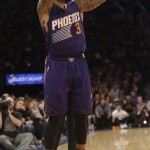Phoenix Suns' Isaiah Thomas (3) shoots a three point basket during the first half of an NBA basketball game against the New York Knicks Saturday, Dec. 20, 2014, in New York. The Suns won the game 99-90. (AP Photo/Frank Franklin II)