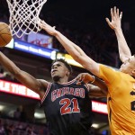Phoenix Suns' Alex Len, right, defends the basket as Chicago Bulls' Jimmy Butler goes up for a shot during the first half of an NBA basketball game Friday, Jan. 30, 2015, in Phoenix. (AP Photo/Ross D. Franklin)