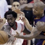 Houston Rockets' Patrick Beverley, left, is fouled by Phoenix Suns' P.J. Tucker as they go after a loose ball in the second half of an NBA basketball game Saturday, Dec. 6, 2014, in Houston. The Rockets won 100-95. (AP Photo/Pat Sullivan)