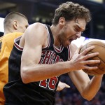 Chicago Bulls' Pau Gasol, right, of Spain, grabs a rebound in front of Phoenix Suns' Alex Len (21), of Ukraine, during the second half of an NBA basketball game Friday, Jan. 30, 2015, in Phoenix. The Suns defeated the Bulls 99-93. (AP Photo/Ross D. Franklin)