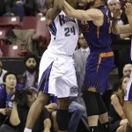 Phoenix Suns center Miles Plumlee, right, knocks the rebound away from Sacramento Kings forward Carl Landry, left, during the first quarter of an NBA basketball game in Sacramento, Calif., Friday, Dec. 26, 2014. (AP Photo/Rich Pedroncelli)
