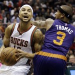 Milwaukee Bucks' Jerryd Bayless drives past Phoenix Suns' Isaiah Thomas (3) during the first half of an NBA basketball game Tuesday, Jan. 6, 2015, in Milwaukee. (AP Photo/Morry Gash)