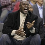 Charlotte Hornets owner Michael Jordan reacts to a call during the second half of the Hornets' NBA basketball game against the Phoenix Suns in Charlotte, N.C., Wednesday, Dec. 17, 2014. The Suns won 111-106. (AP Photo/Chuck Burton)
